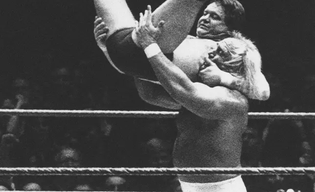 FILE - Wrestler Hulk Hogan prepares to slam "Rowdy" Roddy Piper down on the mat during "WrestleMania," a wrestling extravaganza at New York's Madison Square Garden, March 31, 1985. (AP Photo/Ray Stubblebine, File)