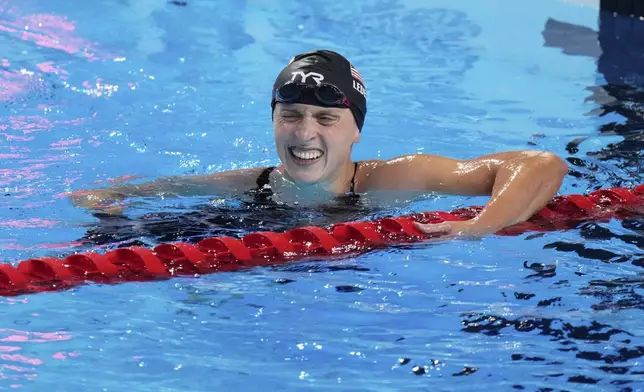 Katie Ledecky of the United States celebrates after winning gold medal in the women's 1500m freestyle final at the World Aquatics Championships in Singapore, Tuesday, July 29, 2025. (AP Photo/Lee Jin-man)