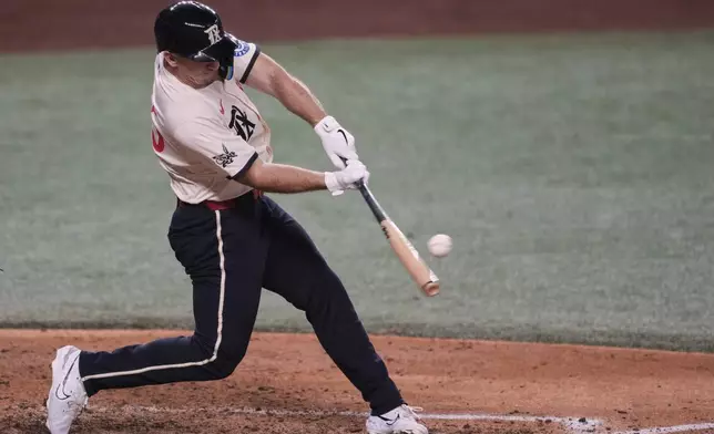 Texas Rangers' Wyatt Langford connects for a run-scoring double in the fourth inning of a baseball game against the Atlanta Braves, Friday, July 25, 2025, in Arlington, Texas. (AP Photo/Tony Gutierrez)