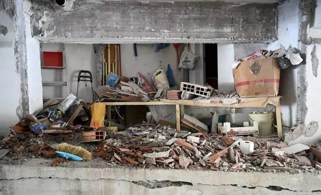 A view of the site where a bomb exploded, at the entrance of the home of president of the Greek association of prison guards, at a suburb of Thessaloniki, northern Greece, Saturday, July 26, 2025. (AP Photo/Giannis Papanikos)