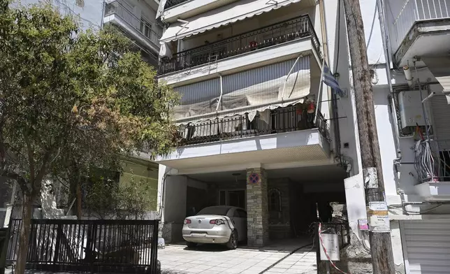 A view of the building where a bomb exploded, at the entrance of the home of president of the Greek association of prison guards, at a suburb of Thessaloniki, northern Greece, Saturday, July 26, 2025. (AP Photo/Giannis Papanikos)