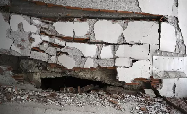 A view of the site where a bomb exploded, at the entrance of the home of president of the Greek association of prison guards, at a suburb of Thessaloniki, northern Greece, Saturday, July 26, 2025. (AP Photo/Giannis Papanikos)