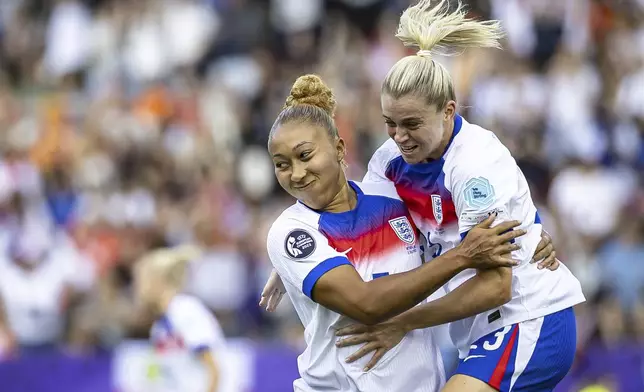 England's Lauren James, right, celebrates with England's Alessia Russo after scoring the opening goal during theEuro 2025, group D, soccer match between England and the Netherlands in Zurich, Switzerland, Wednesday, July 9, 2025. (Michael Buholzer/Keystone via AP)