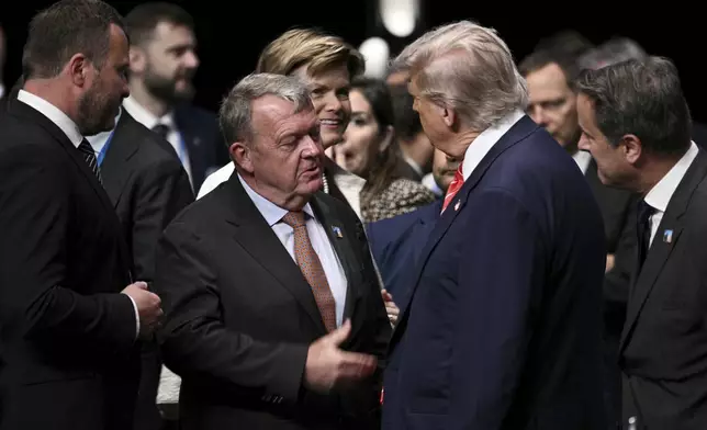 FILE - U.S. President Donald Trump greets Denmark's Foreign Minister Lars Lokke Rasmussen, center left, before the start of a plenary session of the NATO Heads of State and Government summit in The Hague, Netherlands, June 25, 2025.(Brendan Smialowski/Pool Photo via AP File)
