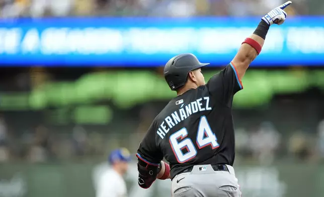 Miami Marlins' Heriberto Hernandez gestures as he rounds the bases after hitting a three-run home run during the fifth inning of a baseball game against the Milwaukee Brewers, Saturday, July 26, 2025, in Milwaukee. (AP Photo/Aaron Gash)