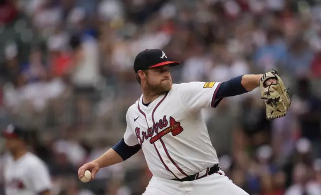 Atlanta Braves pitcher Bryce Elder (55) works against the San Francisco Giants in the first inning of a baseball game, Monday, July 21, 2025, in Atlanta. (AP Photo/Mike Stewart)