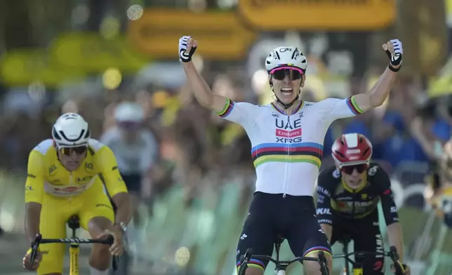 Slovenia's Tadej Pogacar, right, celebrates as he crosses the finish line to win the fourth stage of the Tour de France cycling race over 172.2 kilometers (107 miles) with start in Amiens and finish in Rouen, France, Tuesday, July 8, 2025. (AP Photo/Mosa'ab Elshamy))