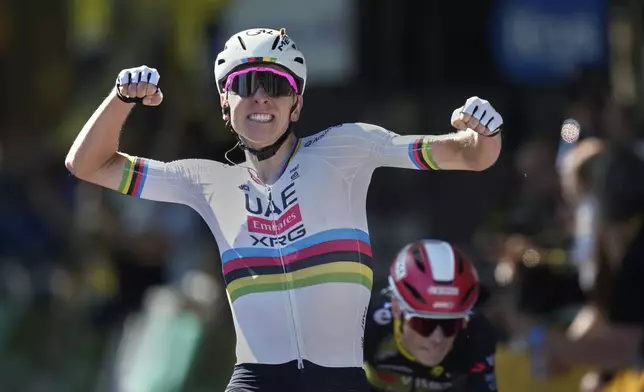 Slovenia's Tadej Pogacar, right, celebrates as he crosses the finish line to win the fourth stage of the Tour de France cycling race over 172.2 kilometers (107 miles) with start in Amiens and finish in Rouen, France, Tuesday, July 8, 2025. (AP Photo/Mosa'ab Elshamy))