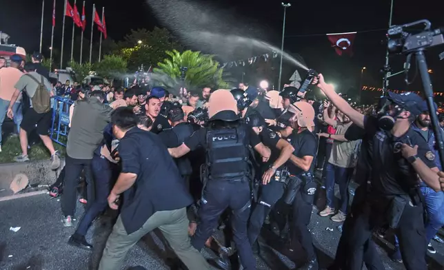 Police use pepper spray to disperse protesters during a rally called by main opposition Republican People's Party or (CHP), in Istanbul, Turkey, Tuesday, July 1, 2025. (AP Photo/Francisco Seco)