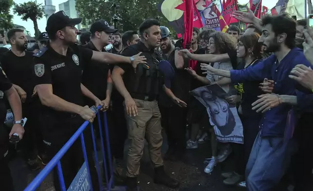 University students scuffle with police during a protest called by main opposition Republican People's Party or (CHP), in Istanbul, Turkey, Tuesday, July 1, 2025. (AP Photo/Francisco Seco)
