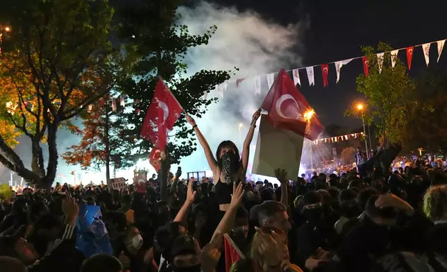 People shout slogans during a protest called by main opposition Republican People's Party or (CHP), outside the City Hall in Istanbul, Turkey, Tuesday, July 1, 2025. (AP Photo/Francisco Seco)