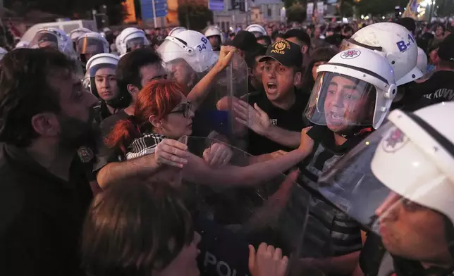 University students scuffle with police during a protest called by main opposition Republican People's Party or (CHP), in Istanbul, Turkey, Tuesday, July 1, 2025. (AP Photo/Francisco Seco)