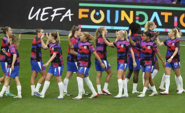 England players great each other prior the Women's Euro 2025 final soccer match between England and Spain at St. Jakob-Park in Basel, Switzerland, Sunday, July 27, 2025. (AP Photo/Michael Probst)