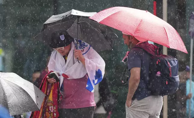 Fans arrive for the Women's Euro 2025 final soccer match between England and Spain at St. Jakob-Park in Basel, Switzerland, Sunday, July 27, 2025. (AP Photo/Martin Meissner)