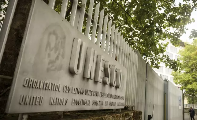 A man enters the UNESCO headquarters Tuesday, July 22, 2025 in Paris. (AP Photo/Thomas Padilla)