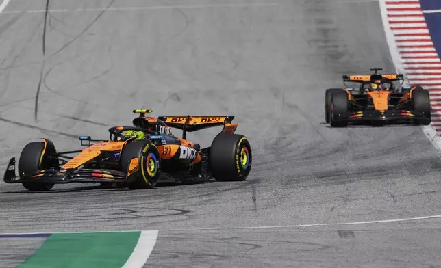 McLaren driver Lando Norris of Britain leads the race in front of McLaren driver Oscar Piastri of Australia during the Austrian Formula One Grand Prix in Spielberg, Austria, Sunday, June 29, 2025. (AP Photo/Darko Bandic)