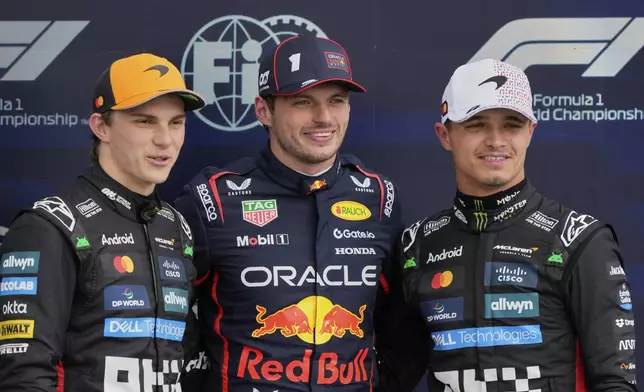 From the left, second-placed McLaren driver Oscar Piastri of Australia, first-placed Red Bull driver Max Verstappen of the Netherlands and third-placed McLaren driver Oscar Piastri of Australia stand on the podium after the qualifying for the British Formula One Grand Prix in Silverstone, England, Saturday, July 5, 2025. (AP Photo/Darko Bandic)