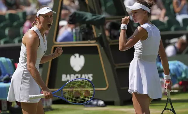 Russia's Veronika Kudermetova, right, and Elise Mertens of Belgium react as they win the second set against Su-Wei Hsieh of Taiwan and Latvia's Jelena Ostapenko during the women's doubles final at the Wimbledon Tennis Championships in London, Sunday, July 13, 2025. (AP Photo/Kin Cheung)