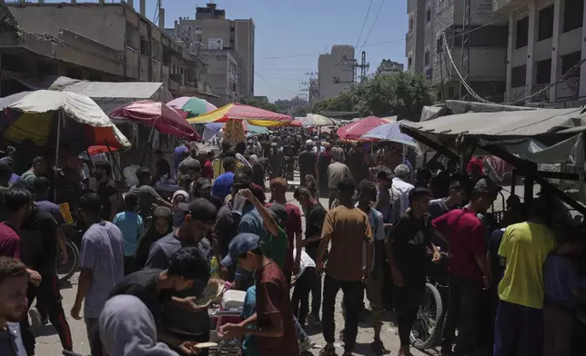 People walk through the Al-Sahaba Market in the center of Gaza City on Wednesday, July 9, 2025. (AP Photo/Jehad Alshrafi)
