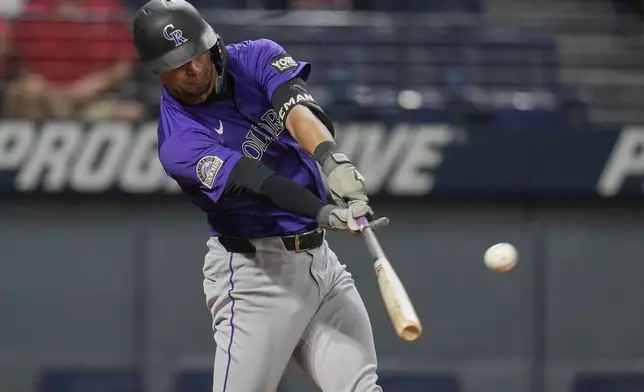 Colorado Rockies' Tyler Freeman hits an RBI single in the fifth inning of a baseball game against the Cleveland Guardians in Cleveland, Monday, July 28, 2025. (AP Photo/Sue Ogrocki)