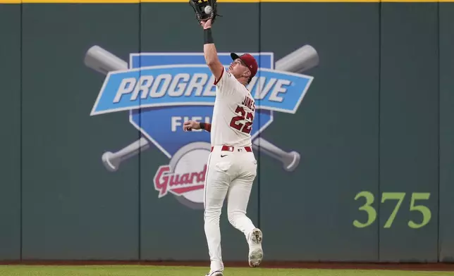 Cleveland Guardians' Nolan Jones (22) catches a fly ball hit for an out by Colorado Rockies' Mickey Moniak in the third inning of a baseball game in Cleveland, Monday, July 28, 2025. (AP Photo/Sue Ogrocki)