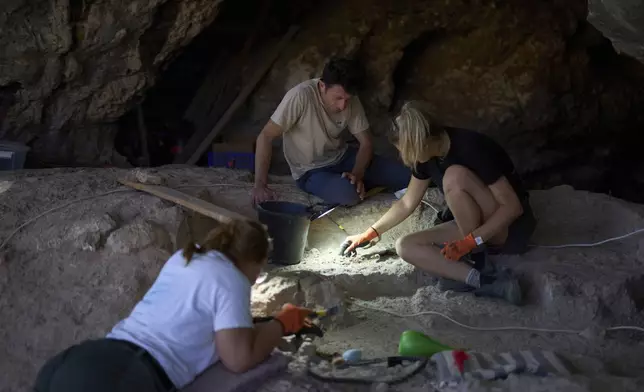 Professor of Archaeology Yossi Zaidner works in Tinshemet Cave, where archaeologists are excavating one of the world's oldest known burial sites, dating back 100,000 years, near Shoam, Israel, Tuesday, July 15, 2025. (AP Photo/Ariel Schalit)