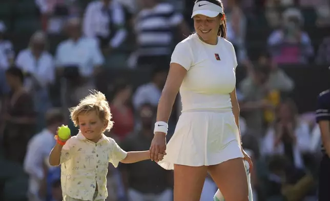 Amanda Anisimova of the U.S. celebrates with her nephew Jackson winning the women's singles quarter finals match against Anastasia Pavlyuchenkova of Russia at the Wimbledon Tennis Championships in London, Tuesday, July 8, 2025.(AP Photo/Kin Cheung)