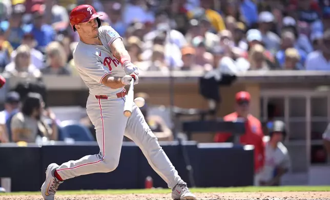 Philadelphia Phillies' J.T. Realmuto hits an RBI double during the eighth inning of a baseball game against the San Diego Padres, Sunday, July 13, 2025, in San Diego. (AP Photo/Orlando Ramirez)
