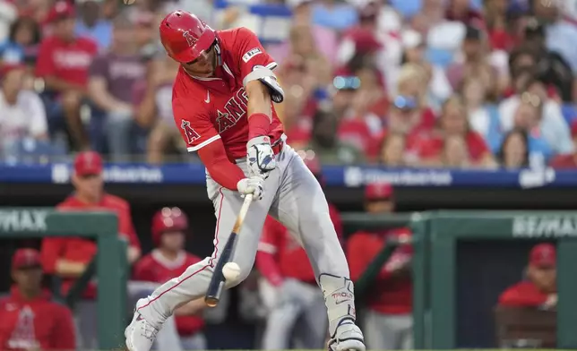 Los Angeles Angels' Mike Trout hits a run-scoring single against Philadelphia Phillies pitcher Jesús Luzardo during the fifth inning of a baseball game Friday, July 18, 2025, in Philadelphia. (AP Photo/Matt Slocum)