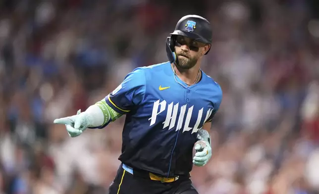 Philadelphia Phillies' Bryce Harper reacts after hitting a home run against Los Angeles Angels pitcher José Fermin during the eighth inning of a baseball game Friday, July 18, 2025, in Philadelphia. (AP Photo/Matt Slocum)