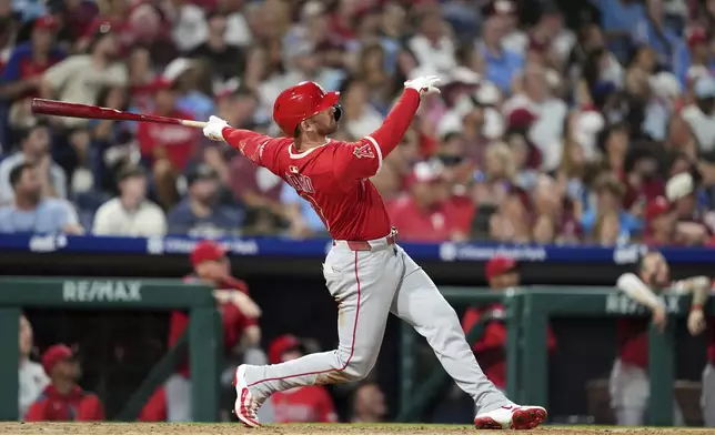 Los Angeles Angels' Taylor Ward follows through after hitting a two-run home run against Philadelphia Phillies pitcher Tanner Banks during the seventh inning of a baseball game Friday, July 18, 2025, in Philadelphia. (AP Photo/Matt Slocum)