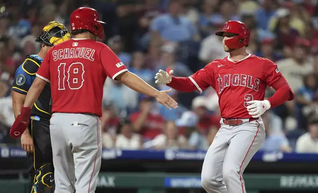 Los Angeles Angels' Taylor Ward, right, and Nolan Schanuel celebrate after Ward's two-run home run against Philadelphia Phillies pitcher Tanner Banks during the seventh inning of a baseball game Friday, July 18, 2025, in Philadelphia. (AP Photo/Matt Slocum)