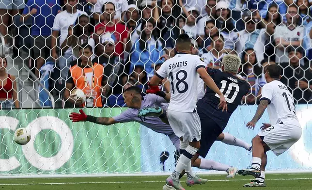United States midfielder Diego Luna (10) scores a goal past Guatemala goalkeeper Kenderson Navarrol, left, during the first half of a CONCACAF Gold Cup semifinal soccer match, Wednesday, July 2, 2025, in St. Louis. (AP Photo/Scott Kane)
