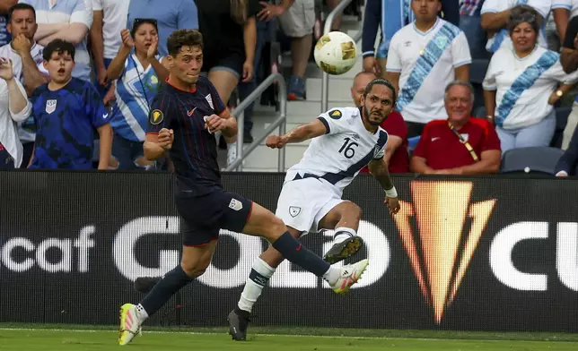 Guatemala defender Jose Morales (16) clears the ball while under pressure from United States midfielder Sebastian Berhalter, left, during the first half of a CONCACAF Gold Cup semifinal soccer match, Wednesday, July 2, 2025, in St. Louis. (AP Photo/Scott Kane)