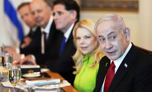Israel's Prime Minister Benjamin Netanyahu, from right, attends a meeting with President Donald Trump, not pictured, as Netanyahu's his wife Sara Netanyahu, Israel's Strategic Affairs Minister Ron Dermer, Israel's National Security Adviser Tzachi Hanegbi and Israel's Cabinet Secretary Yossi Fuchs listen in the Blue Room of the White House, Monday, July 7, 2025, in Washington. (AP Photo/Alex Brandon)