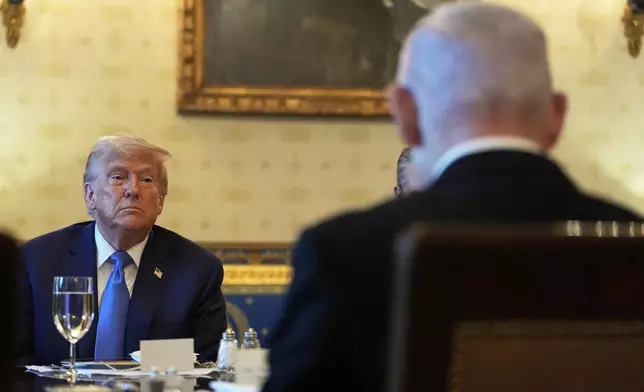 President Donald Trump listens during a meeting with Israel's Prime Minister Benjamin Netanyahu, right, in the Blue Room of the White House, Monday, July 7, 2025, in Washington. (AP Photo/Alex Brandon)