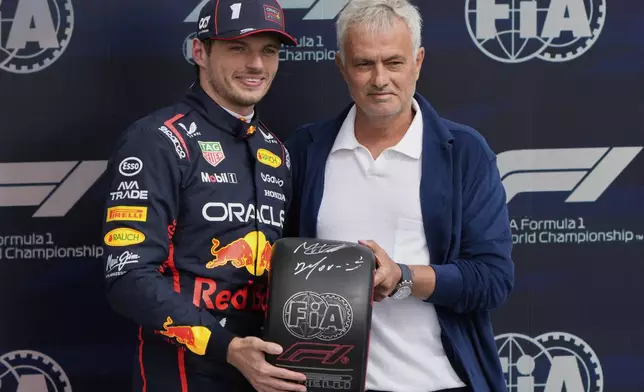 Red Bull driver Max Verstappen of the Netherlands and a soccer coach Jose Mourinho pose after the qualifying for the British Formula One Grand Prix in Silverstone, England, Saturday, July 5, 2025. (AP Photo/Darko Bandic)