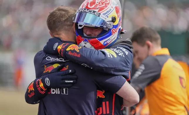 Red Bull driver Max Verstappen of the Netherlands hugs a team memebr after taking the pole position during the qualifying for the British Formula One Grand Prix in Silverstone, England, Saturday, July 5, 2025. (AP Photo/Darko Bandic)