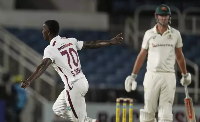 West Indies' Shamar Joseph celebrates taking the wicket of Australia's Beau Webster, right, on day one of the third Test cricket match at Sabina Park in Kingston, Jamaica, Saturday, July 12, 2025. (AP Photo/Ricardo Mazalan)