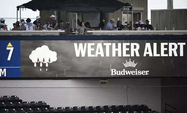 A weather alert message is displayed during a delay in the seventh inning of a baseball game between the Tampa Bay Rays and the Baltimore Orioles, Sunday, July 20, 2025, in Tampa, Fla. (AP Photo/Phelan M. Ebenhack)