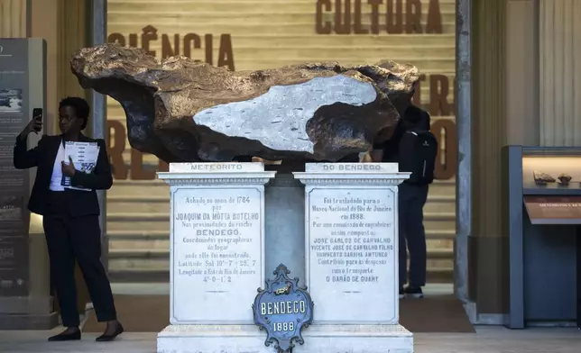 A meteorite stands at the entrance of the National Museum during a press tour in Rio de Janeiro, ahead of its temporrary reopening to the public following a 2018 fire, Monday, June 30, 2025. (AP Photo/Bruna Prado)