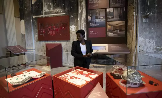 A visitor looks at an exhibit during a press tour at the National Museum in Rio de Janeiro, ahead of its temporary reopening to the public following a 2018 fire, Monday, June 30, 2025. (AP Photo/Bruna Prado)