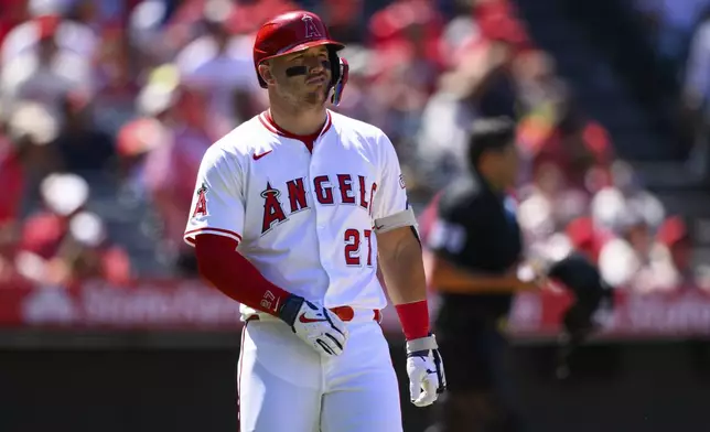 Los Angeles Angels' Mike Trout reacts after hitting a foul ball during the eighth inning of a baseball game against the Seattle Mariners, Sunday, July 27, 2025, in Anaheim, Calif. (AP Photo/William Liang)