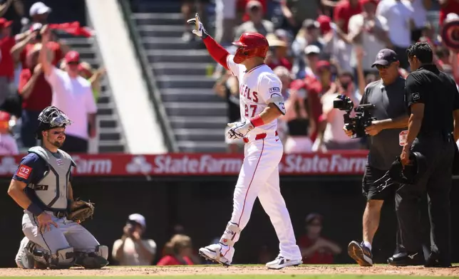 Los Angeles Angels' Mike Trout, center, gestures after hitting a home run during the fifth inning of a baseball game against the Seattle Mariners, Sunday, July 27, 2025, in Anaheim, Calif. (AP Photo/William Liang)