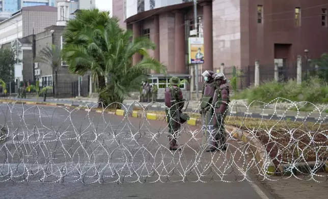 Kenya anti-riot police barricade roads to Parliament buildings with razor wire, ahead of the historic 1990 Saba Saba, a Swahili word that means seven seven, protests for democratic reforms in Nairobi, Kenya Monday, July 7, 2025. (AP Photo/Brian Inganga)