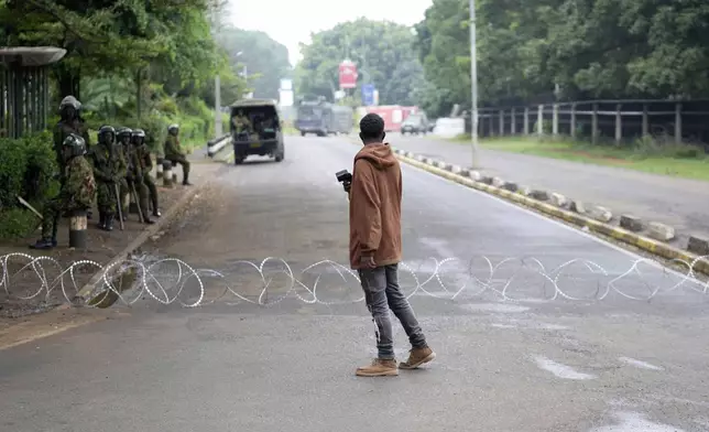 Kenya anti-riot police barricade roads to Parliament buildings with razor wire, ahead of the historic 1990 Saba Saba, a Swahili word that means seven seven, protests for democratic reforms in Nairobi, Kenya Monday, July 7, 2025. (AP Photo/Brian Inganga)