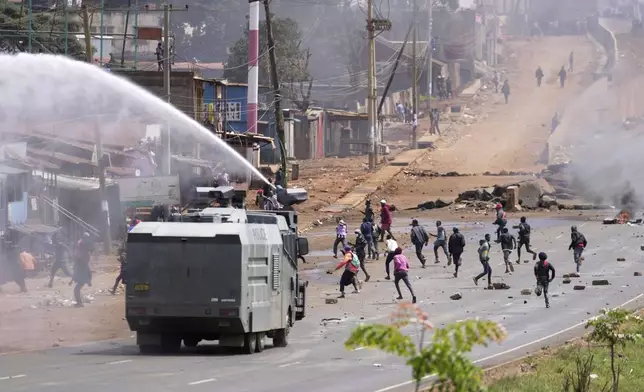 Riot police scatter protesters with water canons during the historic 1990 "Saba Saba" a Swahili word that means seven seven, protests for democratic reforms in the Kangemi slum of Nairobi, Kenya Monday, July 7, 2025. (AP Photo/Brian Inganga)