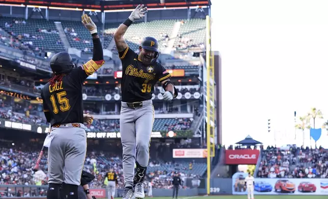 Pittsburgh Pirates' Nick Gonzales (39) celebrates with Oneil Cruz (15) after hitting a solo home run during the first inning of a baseball game against the San Francisco Giants, Monday, July 28, 2025, in San Francisco. (AP Photo/Godofredo A. Vásquez)