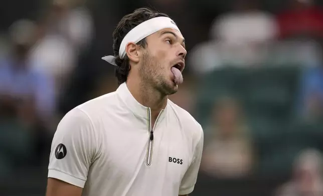 Taylor Fritz of the U.S. reacts during his first round men's single match against Giovanni Mpetshi Perricard of France at the Wimbledon Tennis Championships in London, Monday, June 30, 2025. (AP Photo/Kin Cheung)