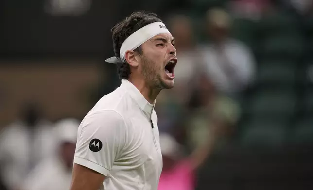 Taylor Fritz of the U.S. reacts during his first round men's single match against Giovanni Mpetshi Perricard of France at the Wimbledon Tennis Championships in London, Monday, June 30, 2025. (AP Photo/Kin Cheung)